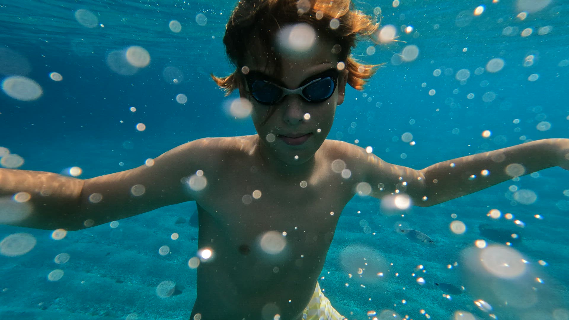 Teenage boy swims underwater