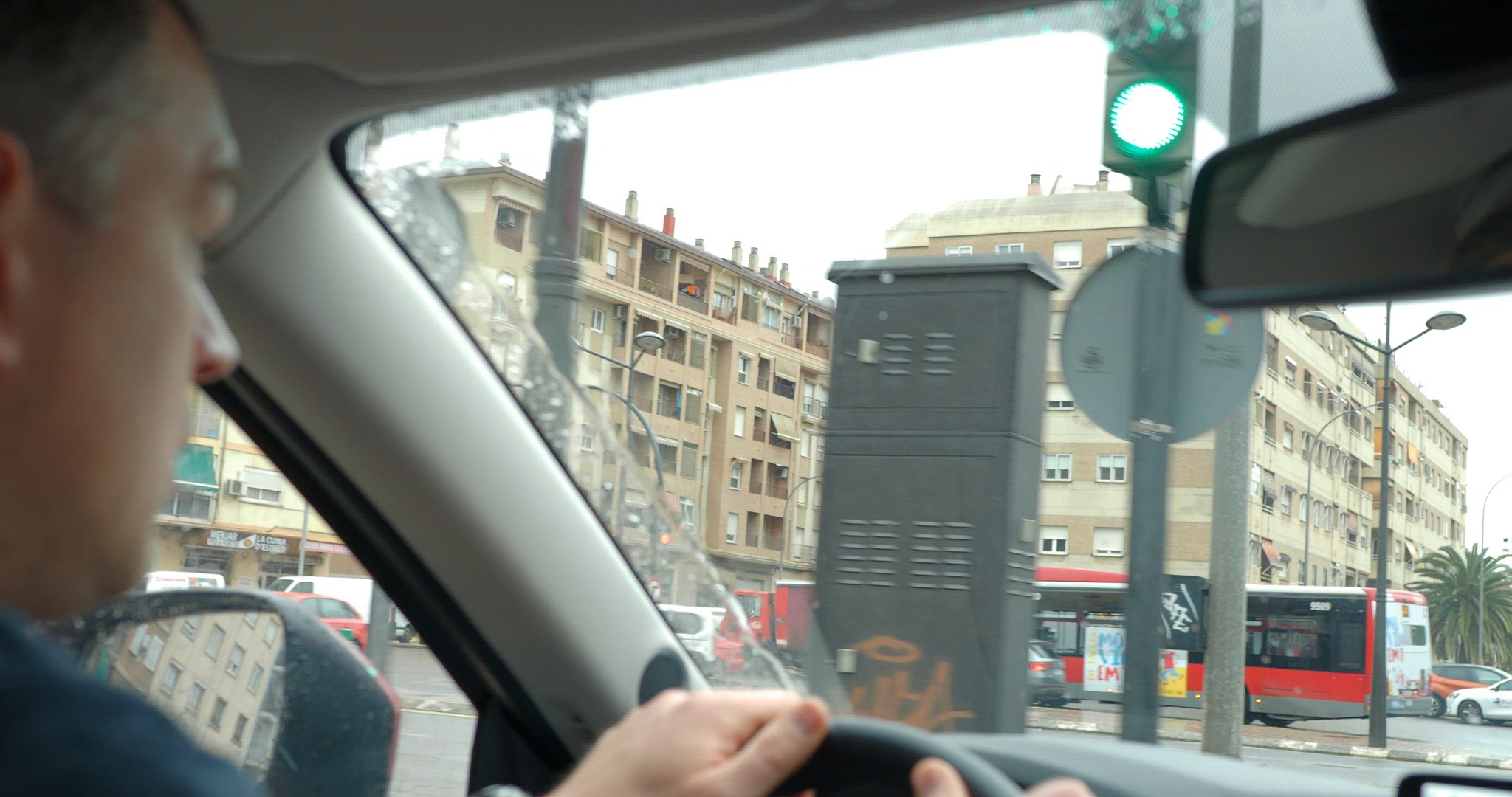Man is very attentive when driving in the city under the rain