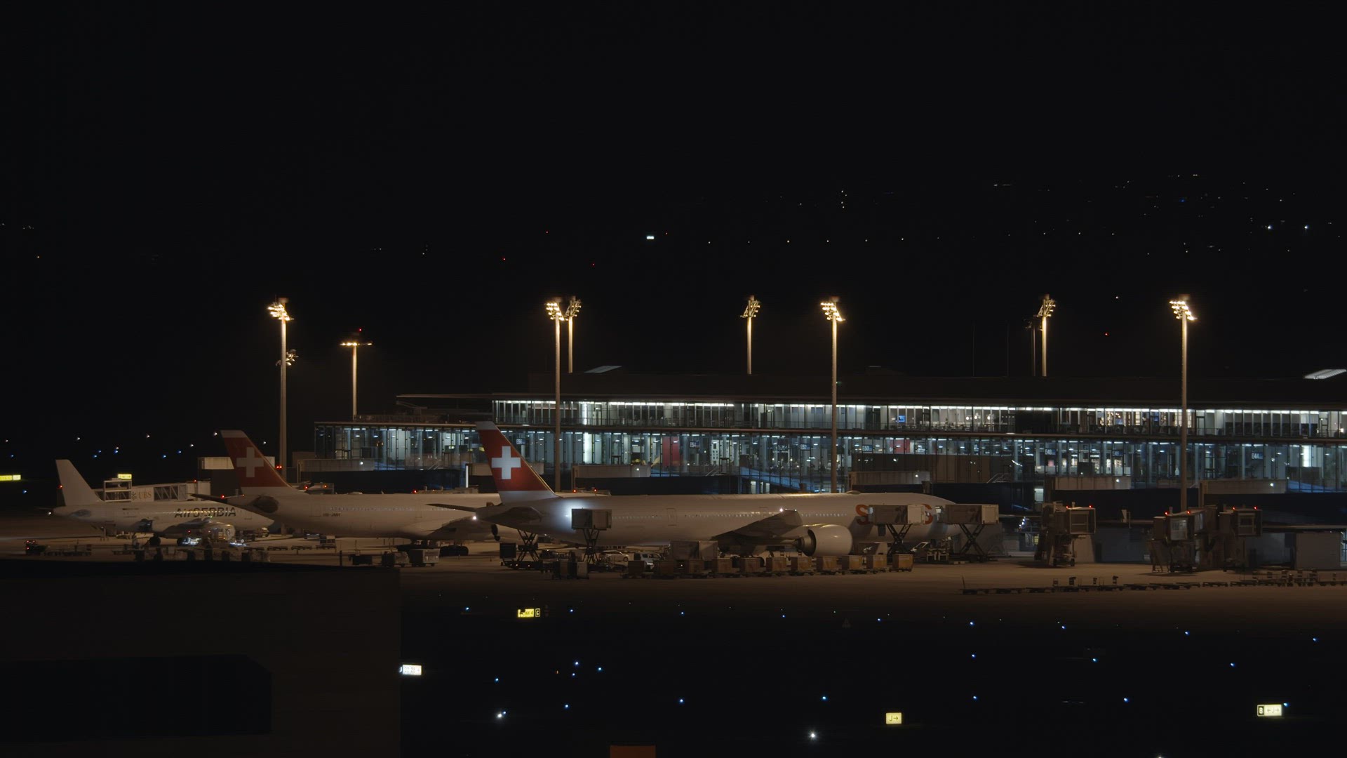 Swiss airlines planes at the airport at night