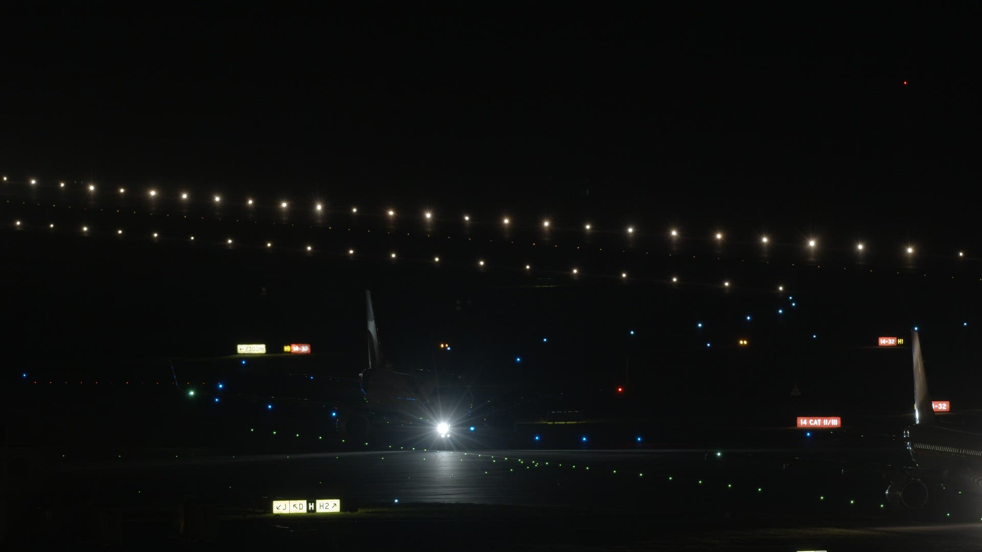 Taxiing airplanes at the airport at night