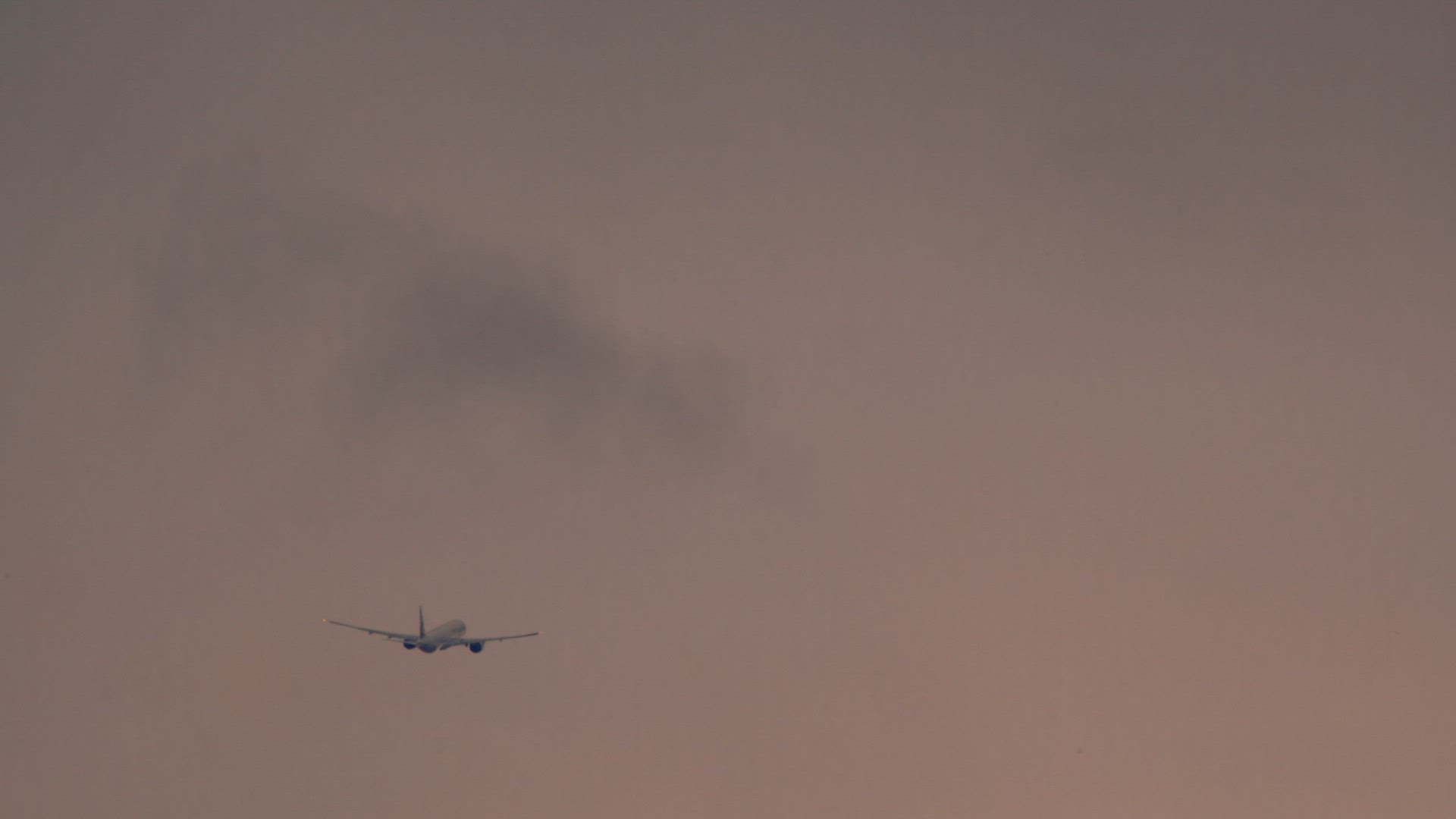 Wide shot of a passenger airplane in the sky