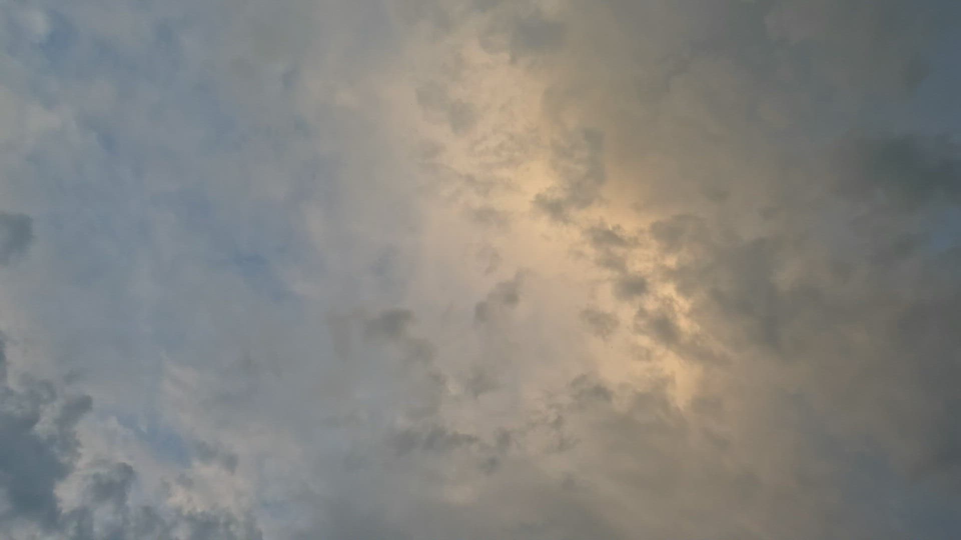 Airplane flies overhead against sunset sky