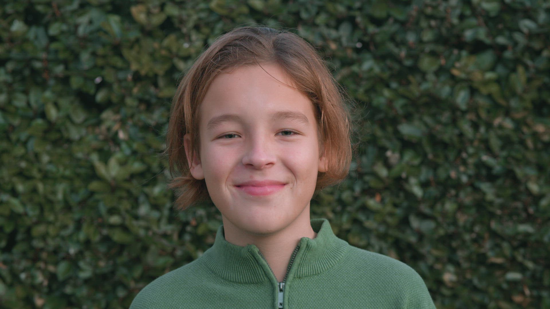 Smiling boy looks to camera