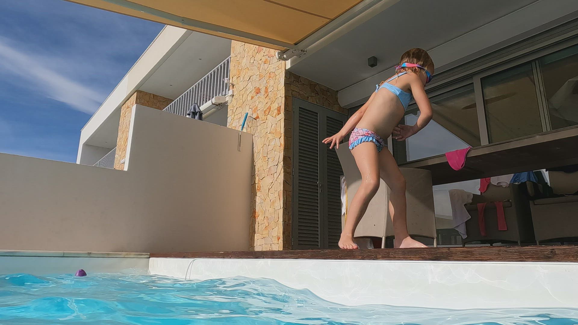 Girl jumps into pool with spin - slow motion