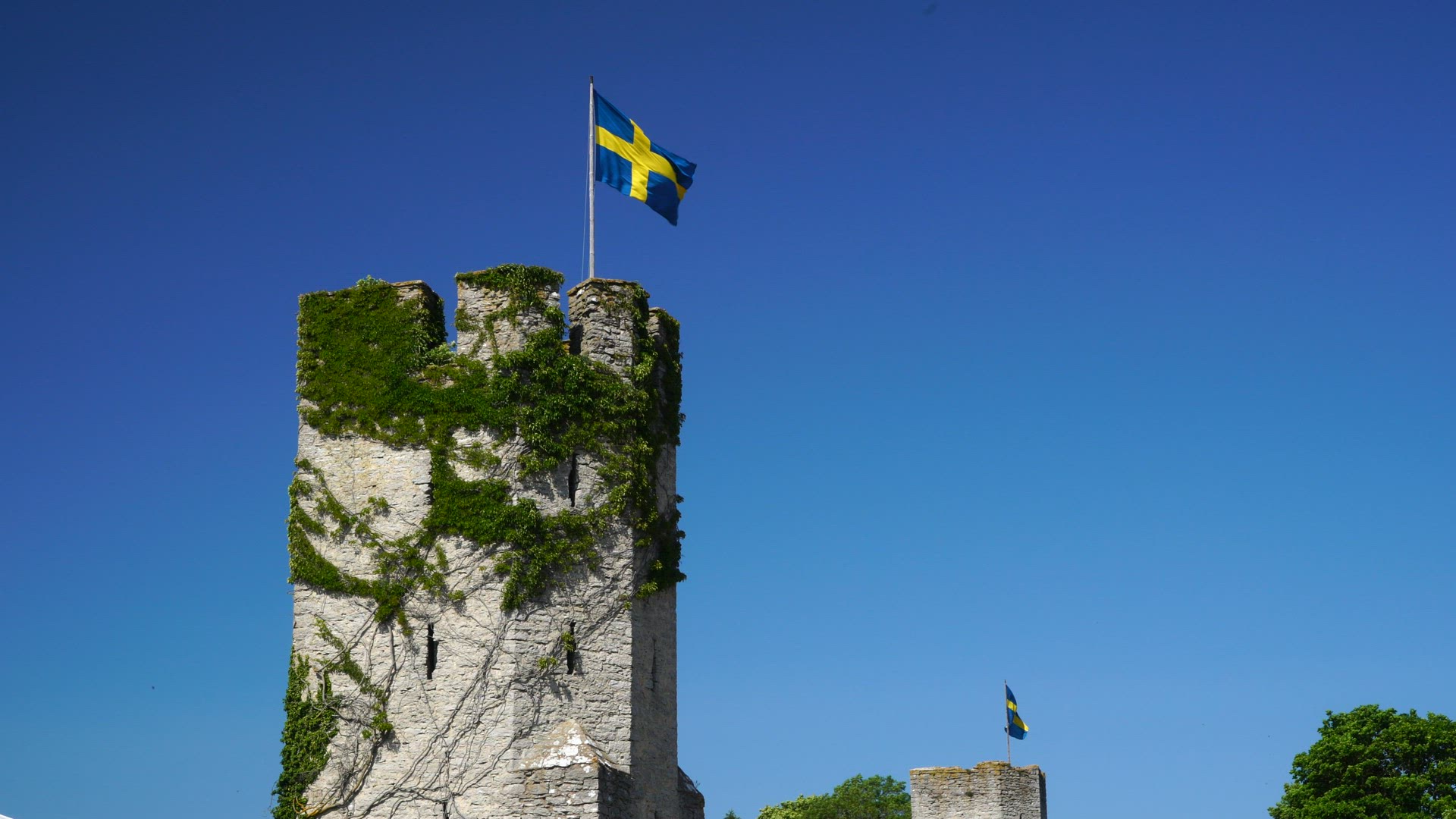 Visby City Wall on Gotland - towers with swedish flags in strong wind