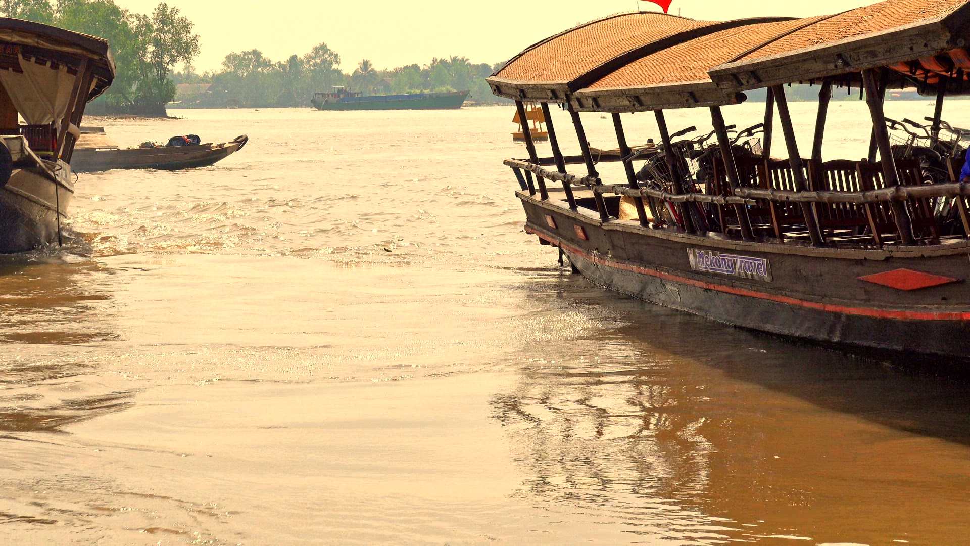 Boats and watercraft moving up a river in Vietnam