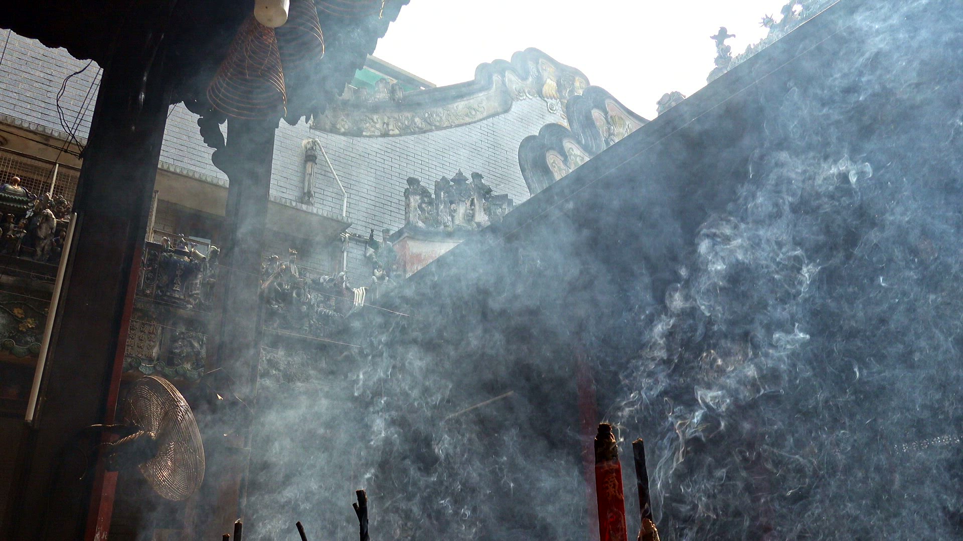 Large pots of incense burning in a temple courtyard in Vietnam