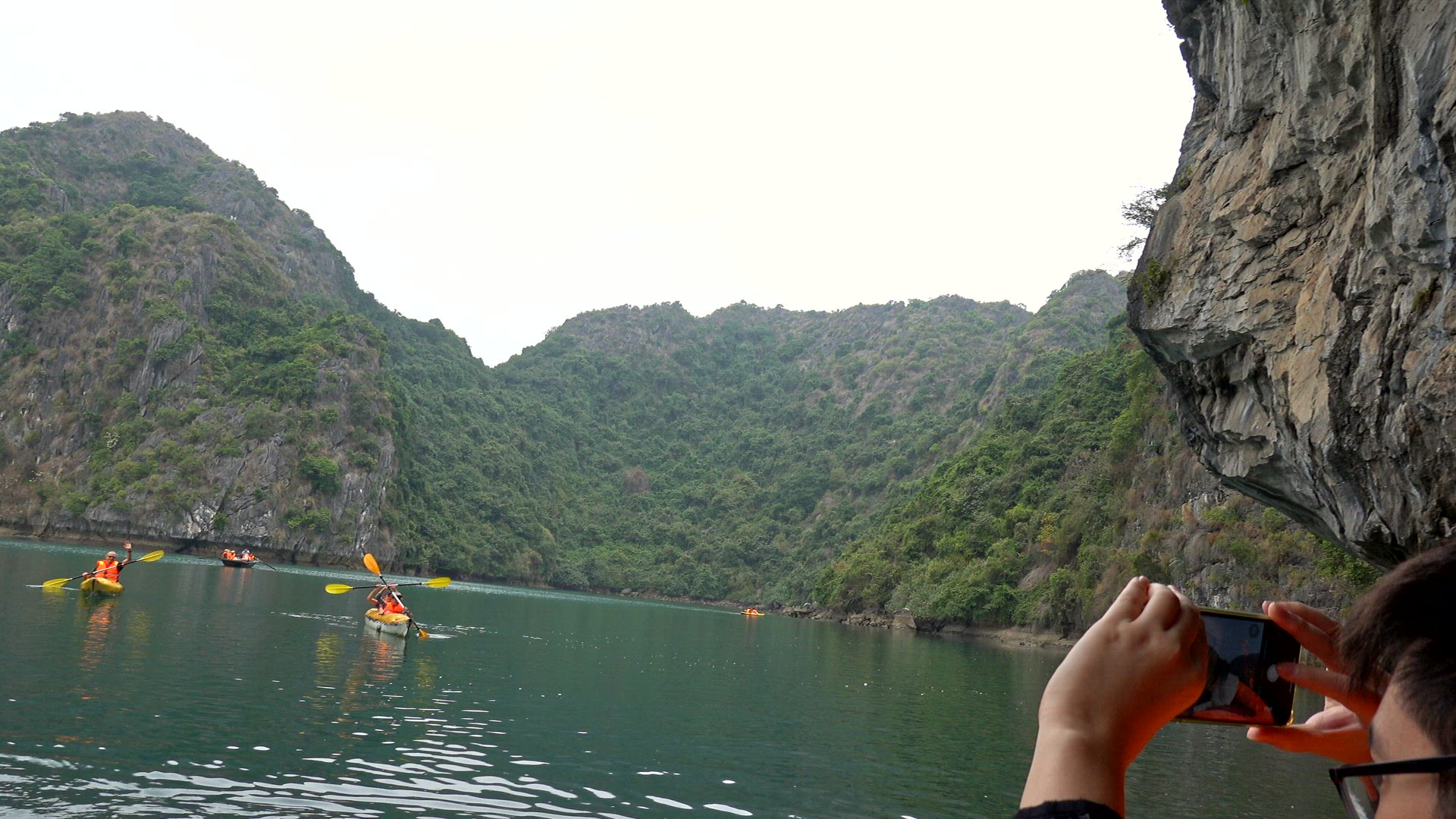 Kayakers paddling amongst the islands of Ha Long Bay