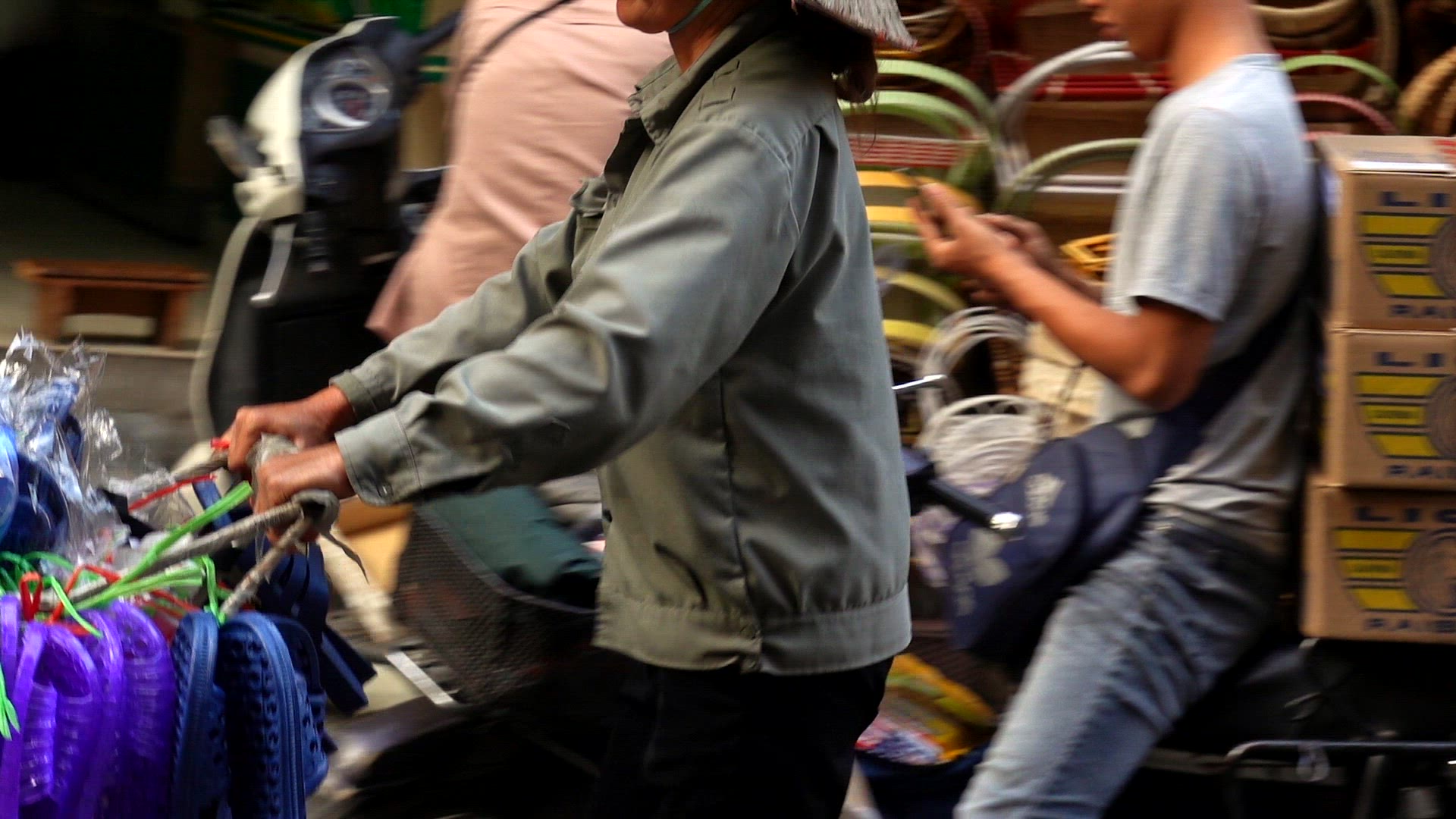 Vendor pushing a cart of shoes