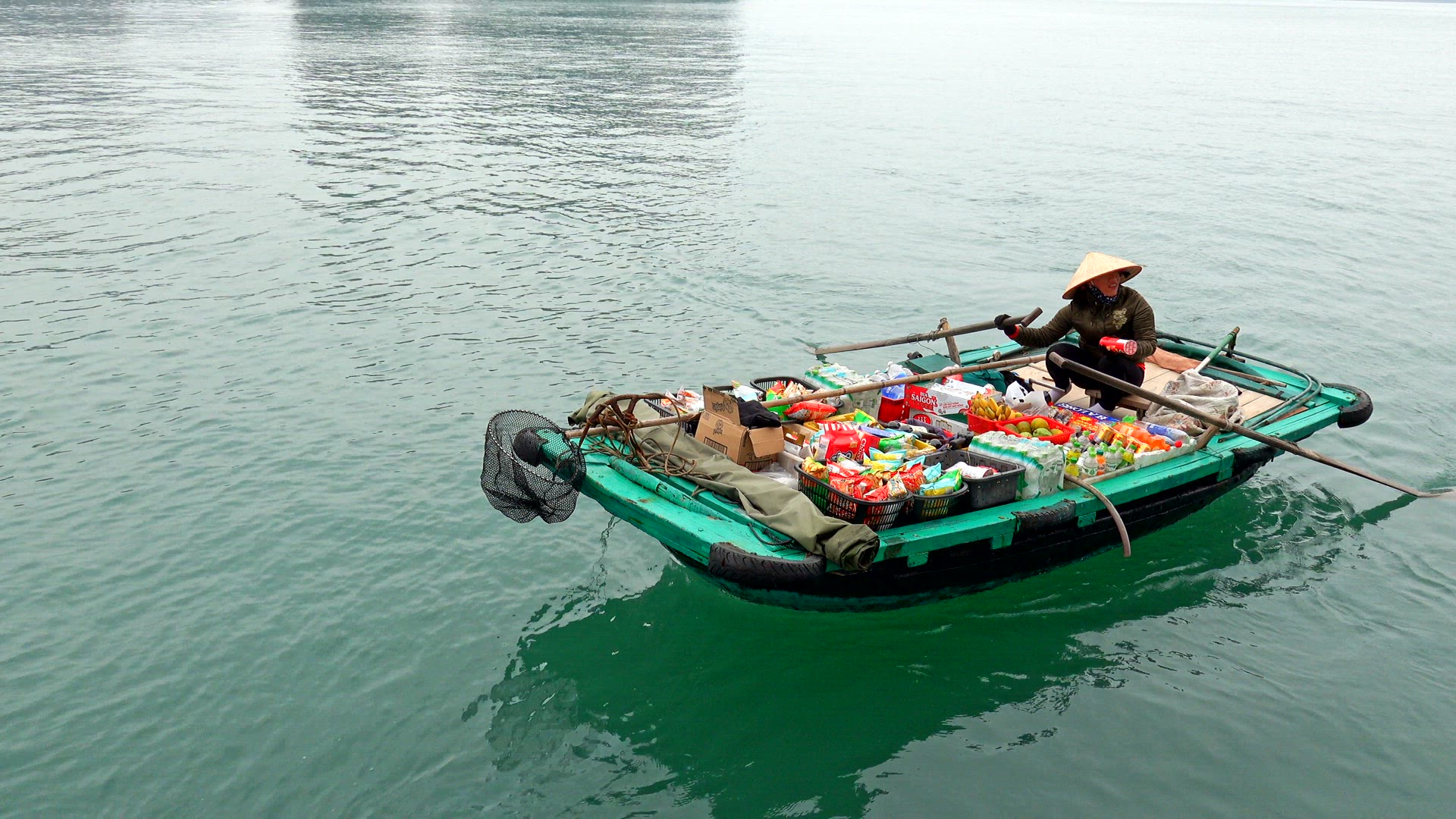 Woman selling fresh produce from her boat