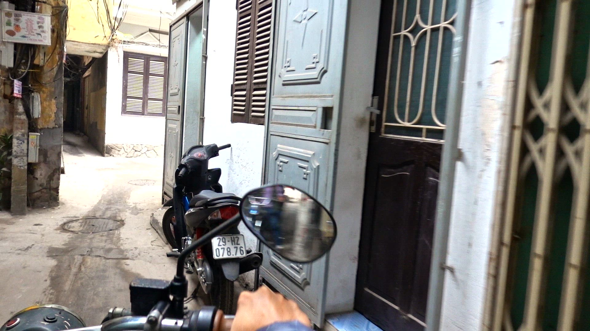 Scooter driving through a windy alley in Hanoi