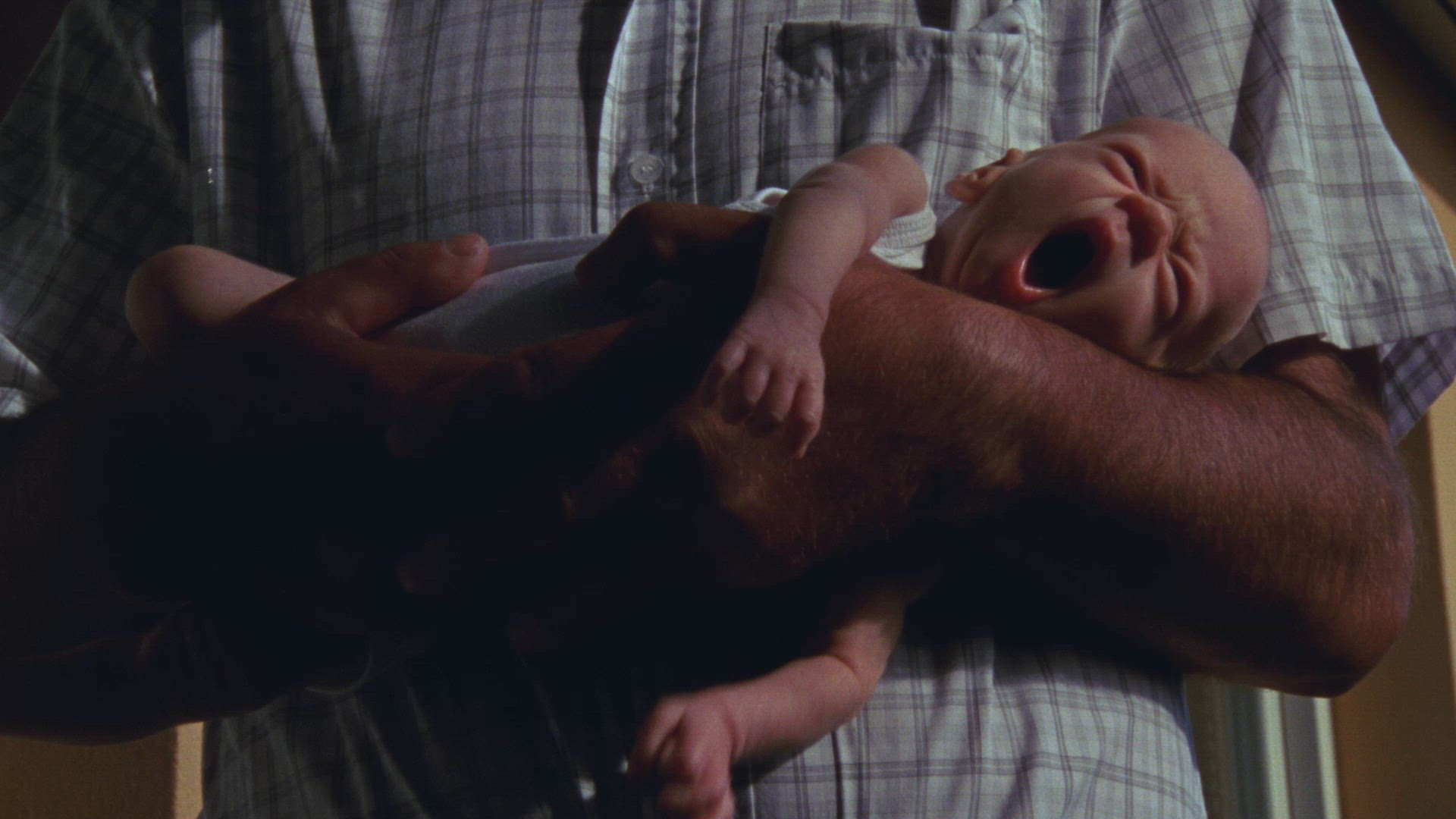 man holding premature boy in his arms