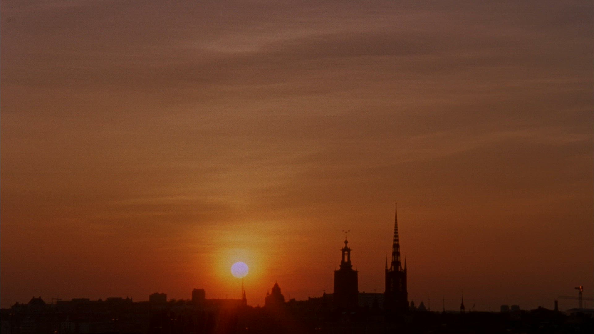 sun set behind stockholm skyline - sun setting - timelapse shot