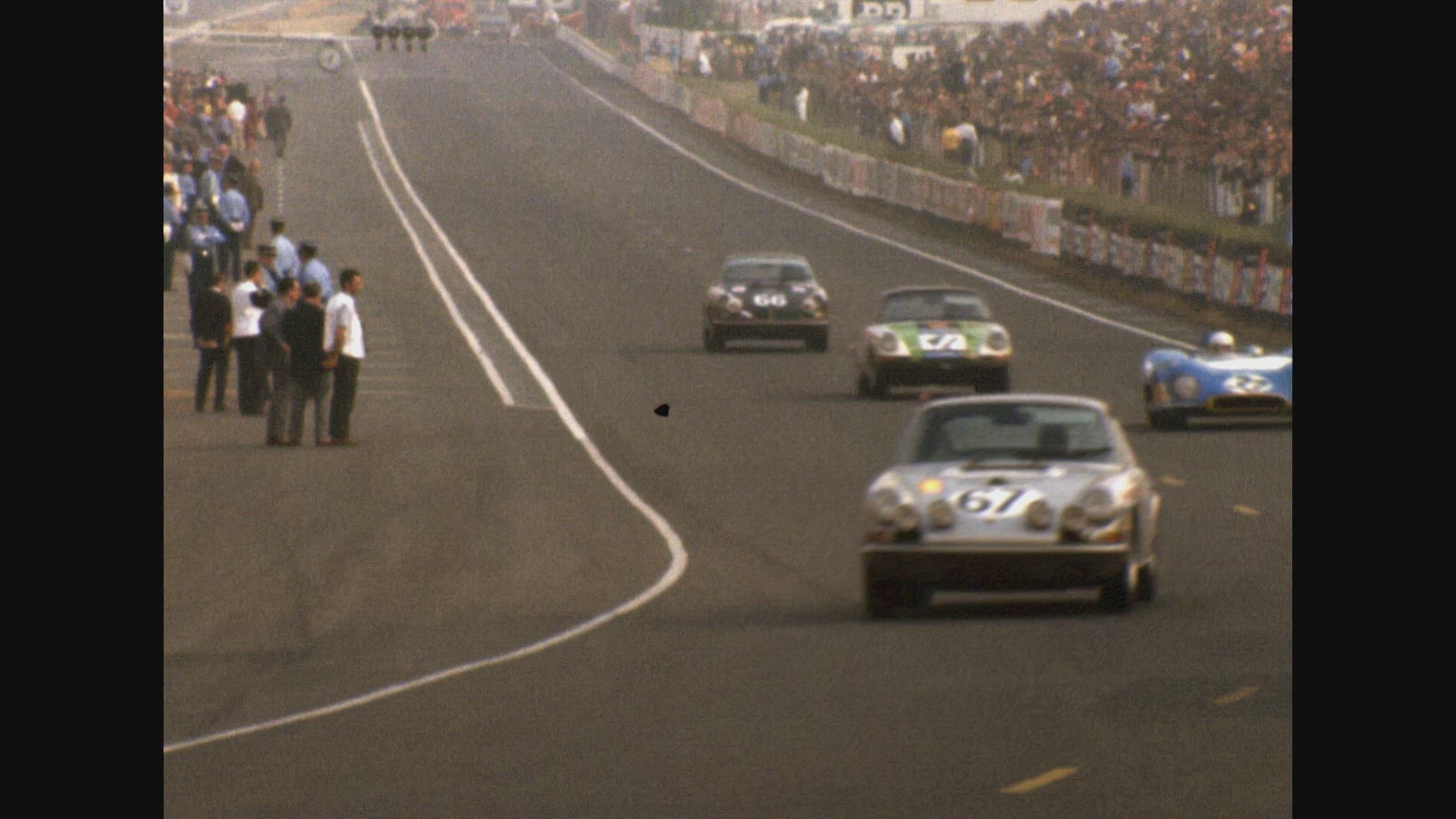 Cars 41 and 61 appraoching curve in track (Le Mans 24 Hour Race 1969)