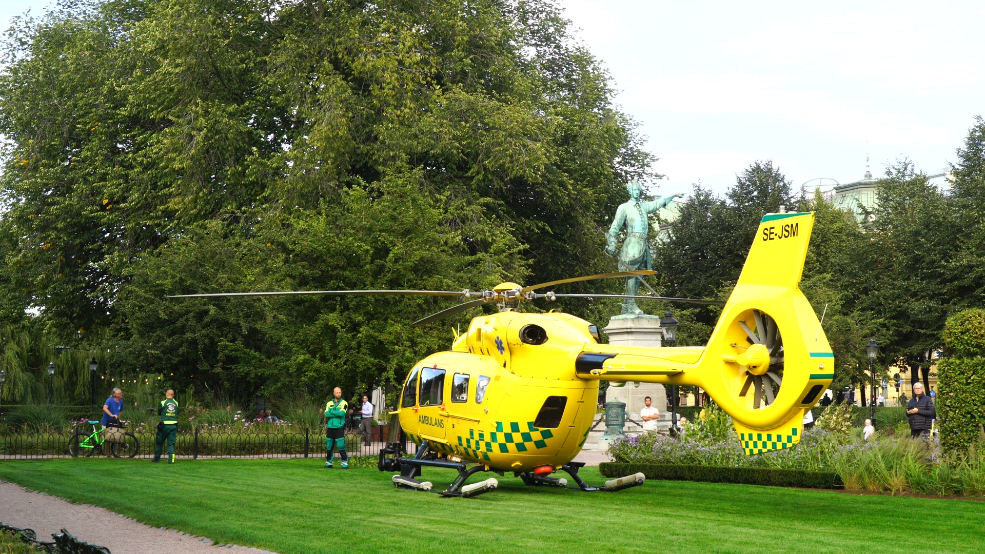 ambulance helicopter parked on lawn in Kungsträdgården in central Stockholm