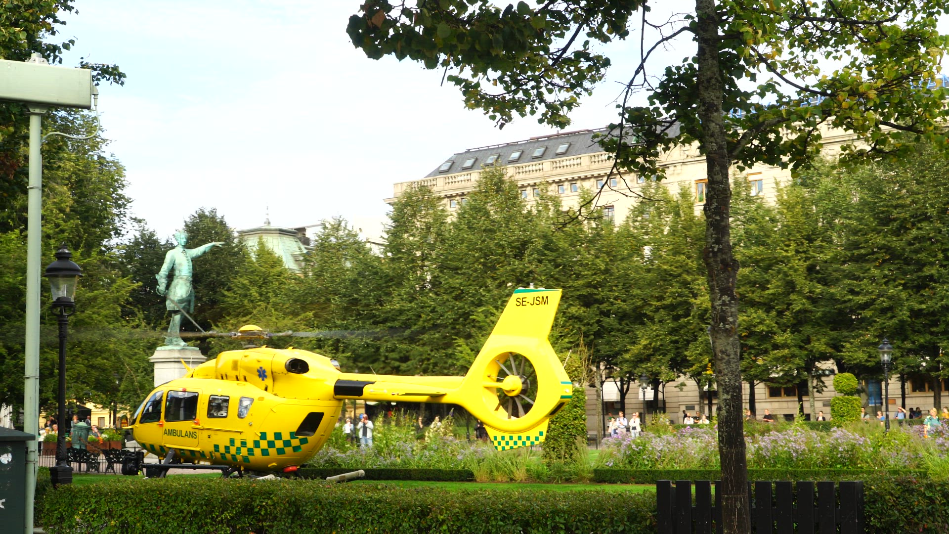 ambulance helicopter taking off from lawn in Kungsträdgården in central Stockholm