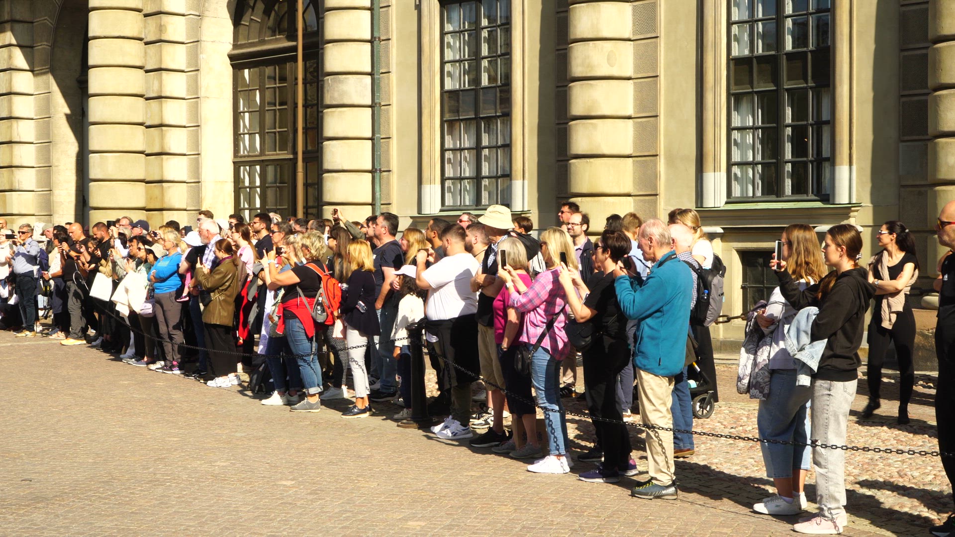 tourists at royal palace watching royal guards marching - spectators