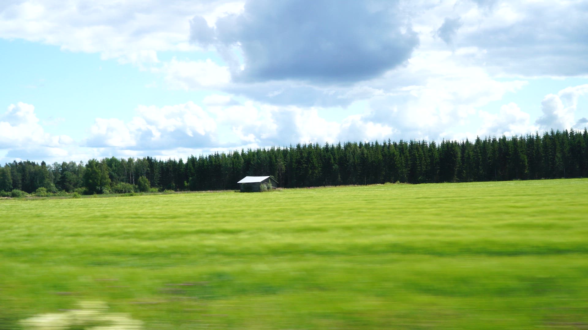 side window view from car - pov field with tool shed - Ostrobothnia in Finland