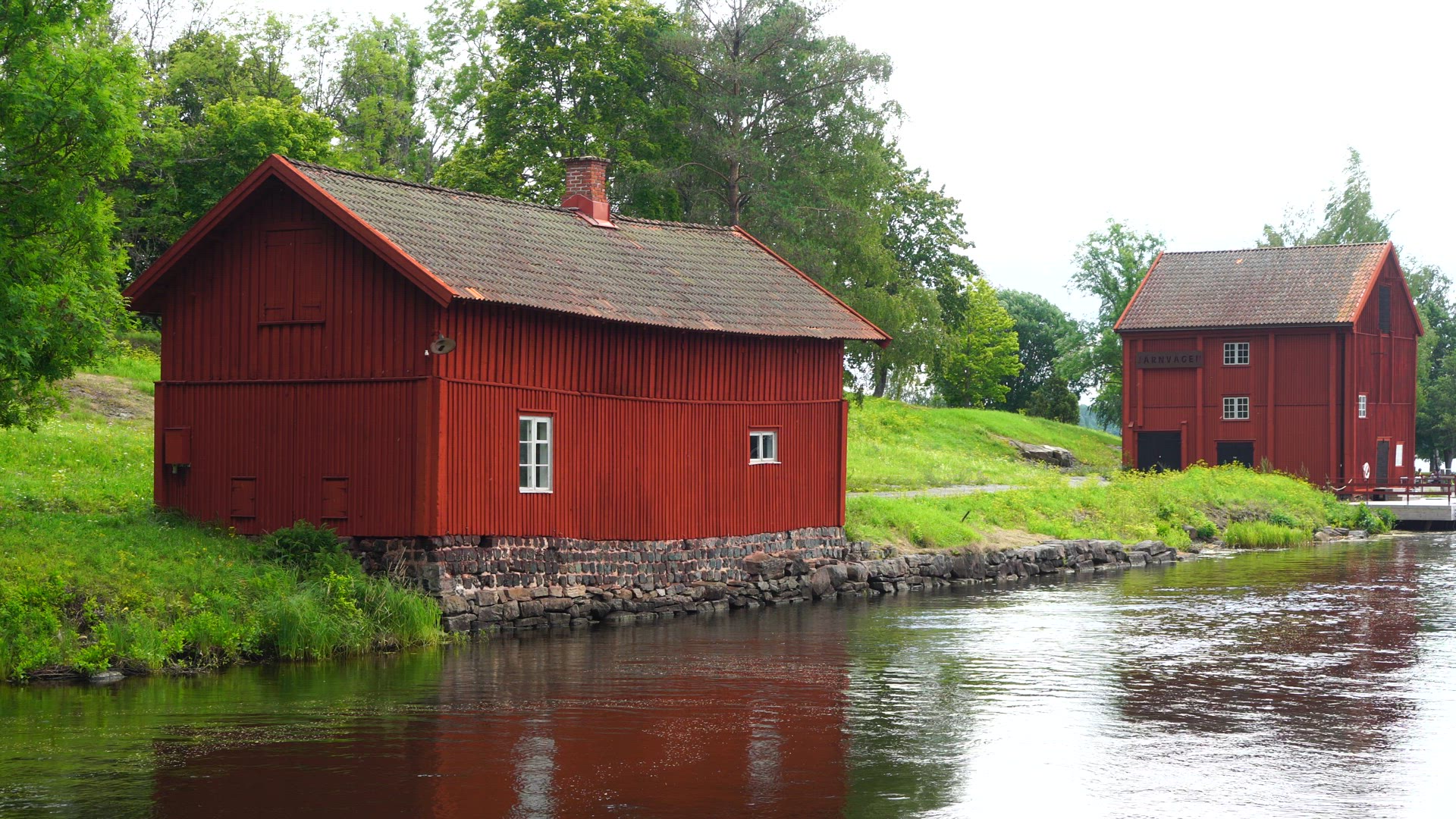 red buildings near water in Borgvik, Värmland