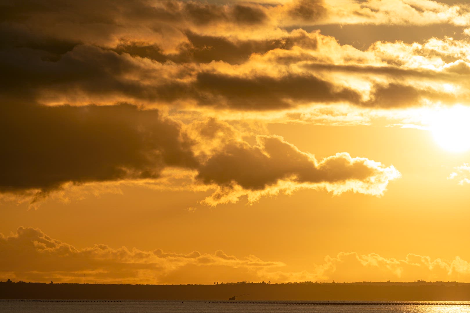 clouds moving in the dusk sky over the sea