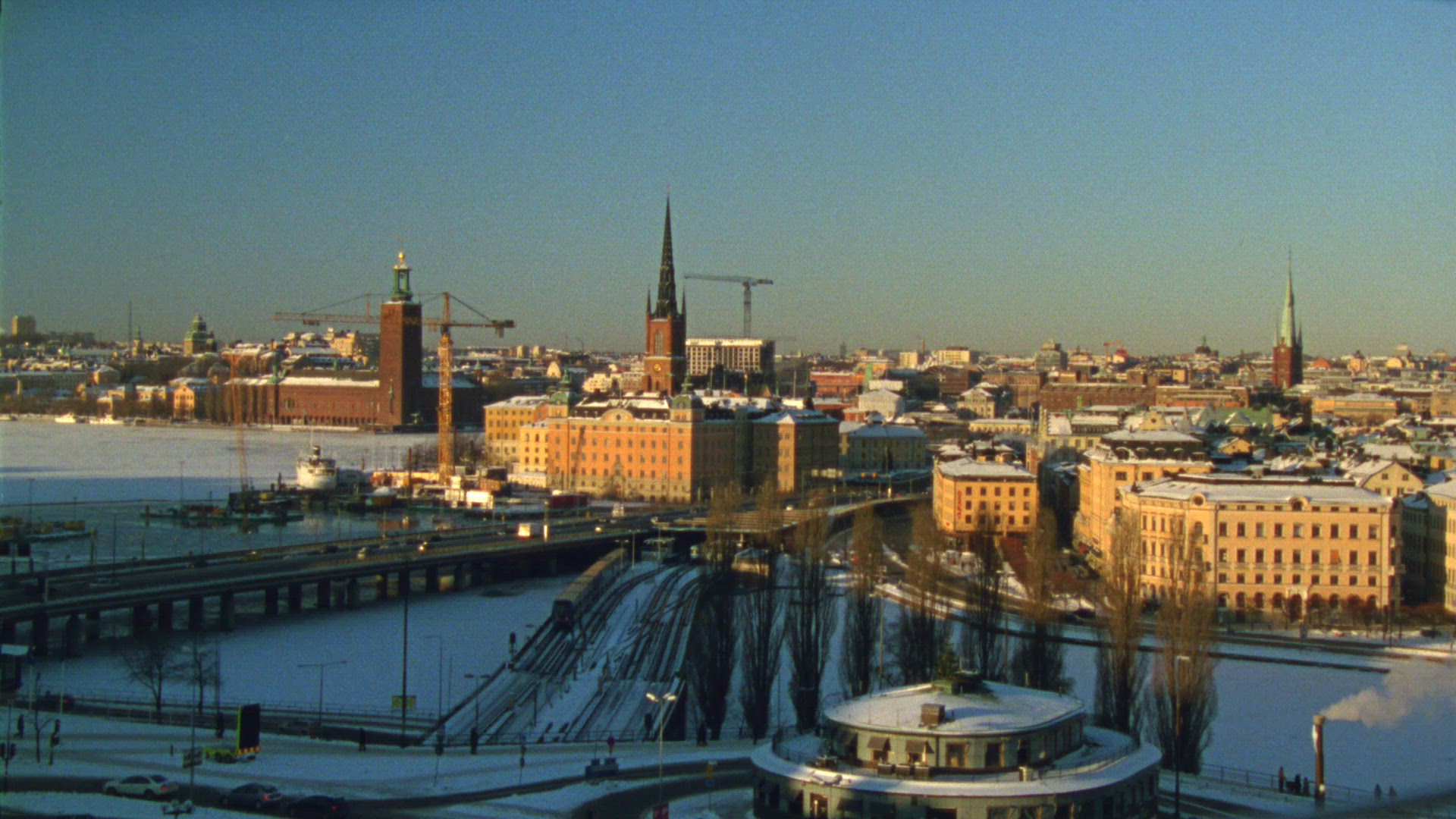 view over slussen, old town, riddarholmen, city hall in central stockholm - wintry weather - winter