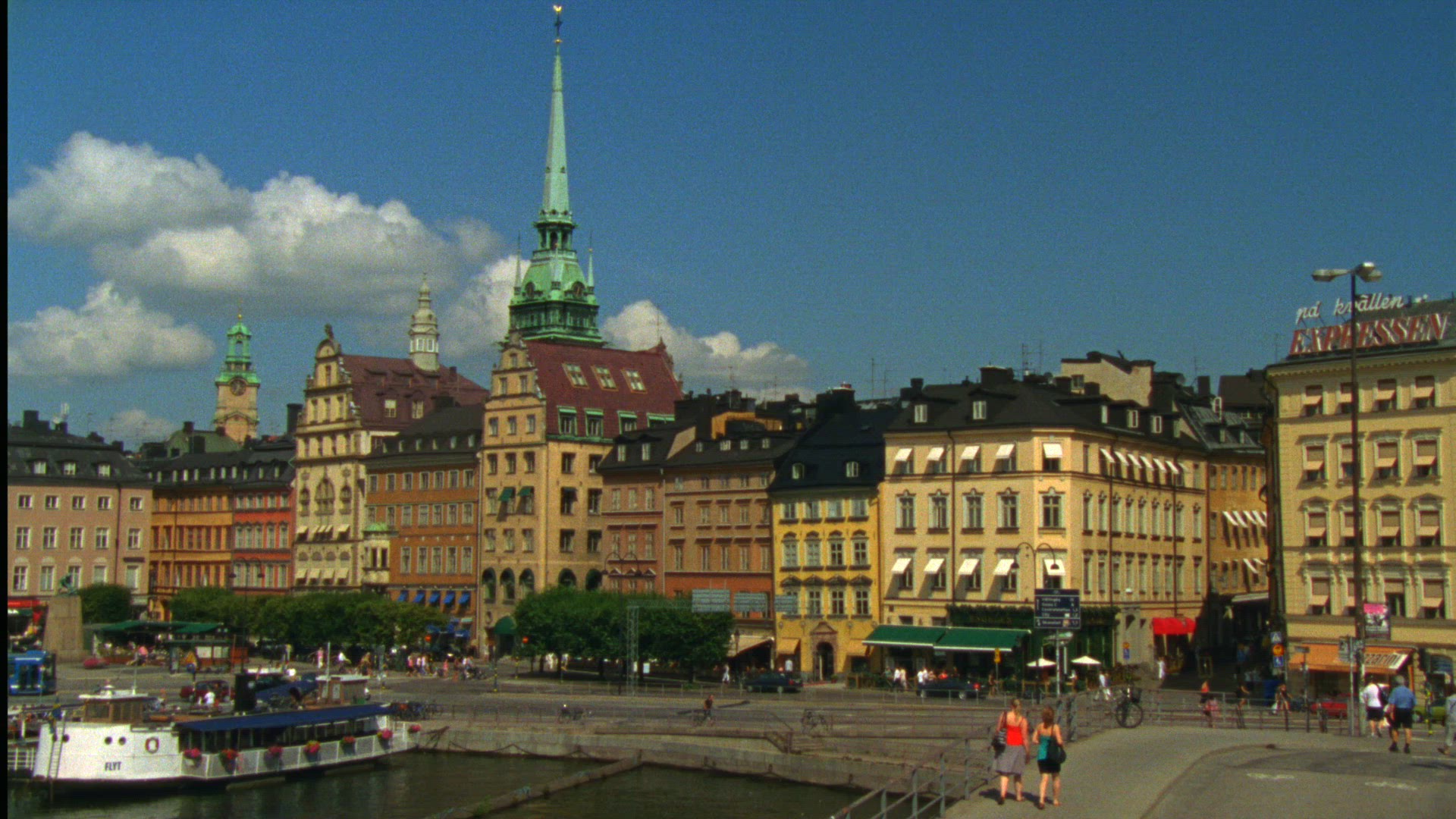 view over buildings and facades in Old Town in Stockholm - tourists taking pictures