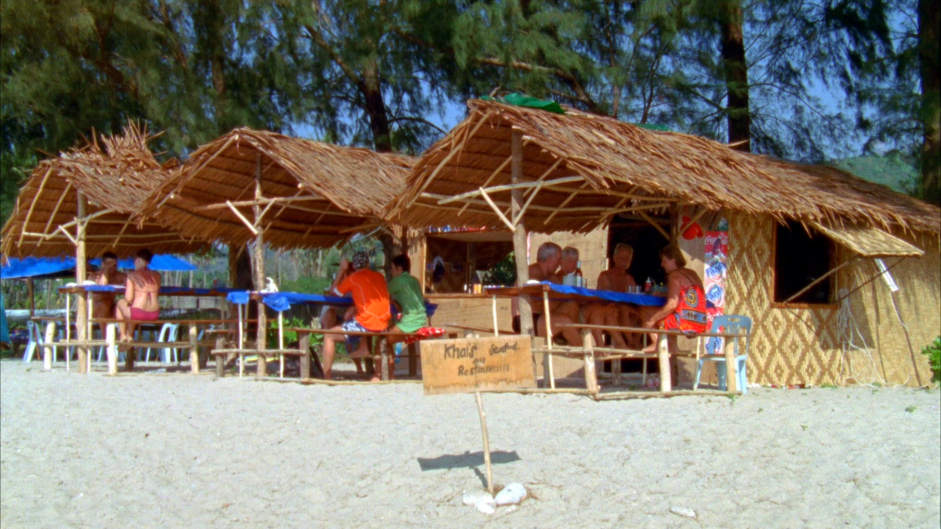 people sitting at outdoor restaurant on beach in Thailand