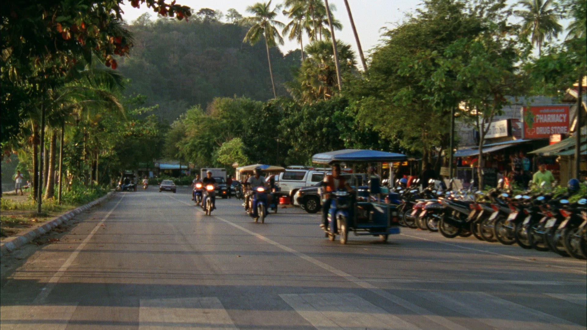 point of view from tuk-tuk - riding down street - traffic