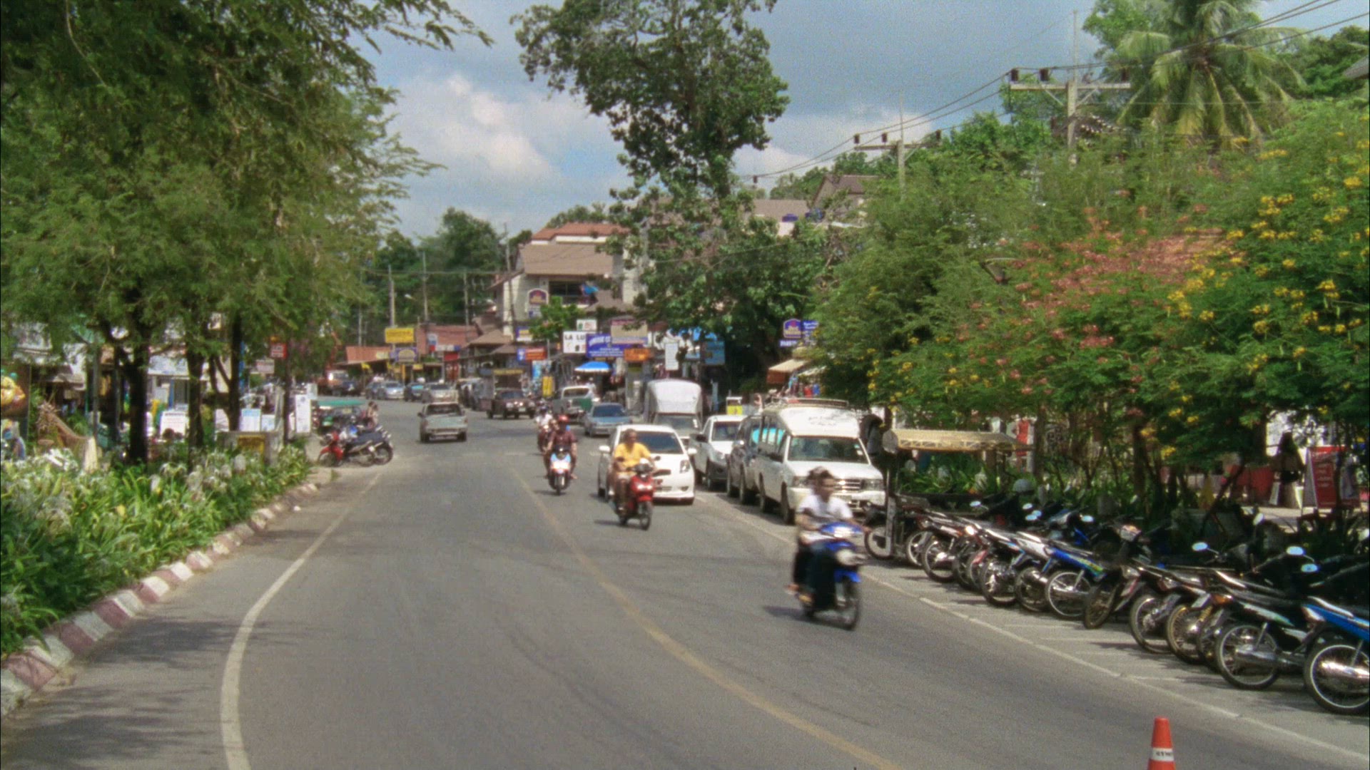 motorcycles - traffic on street in town in Thailand