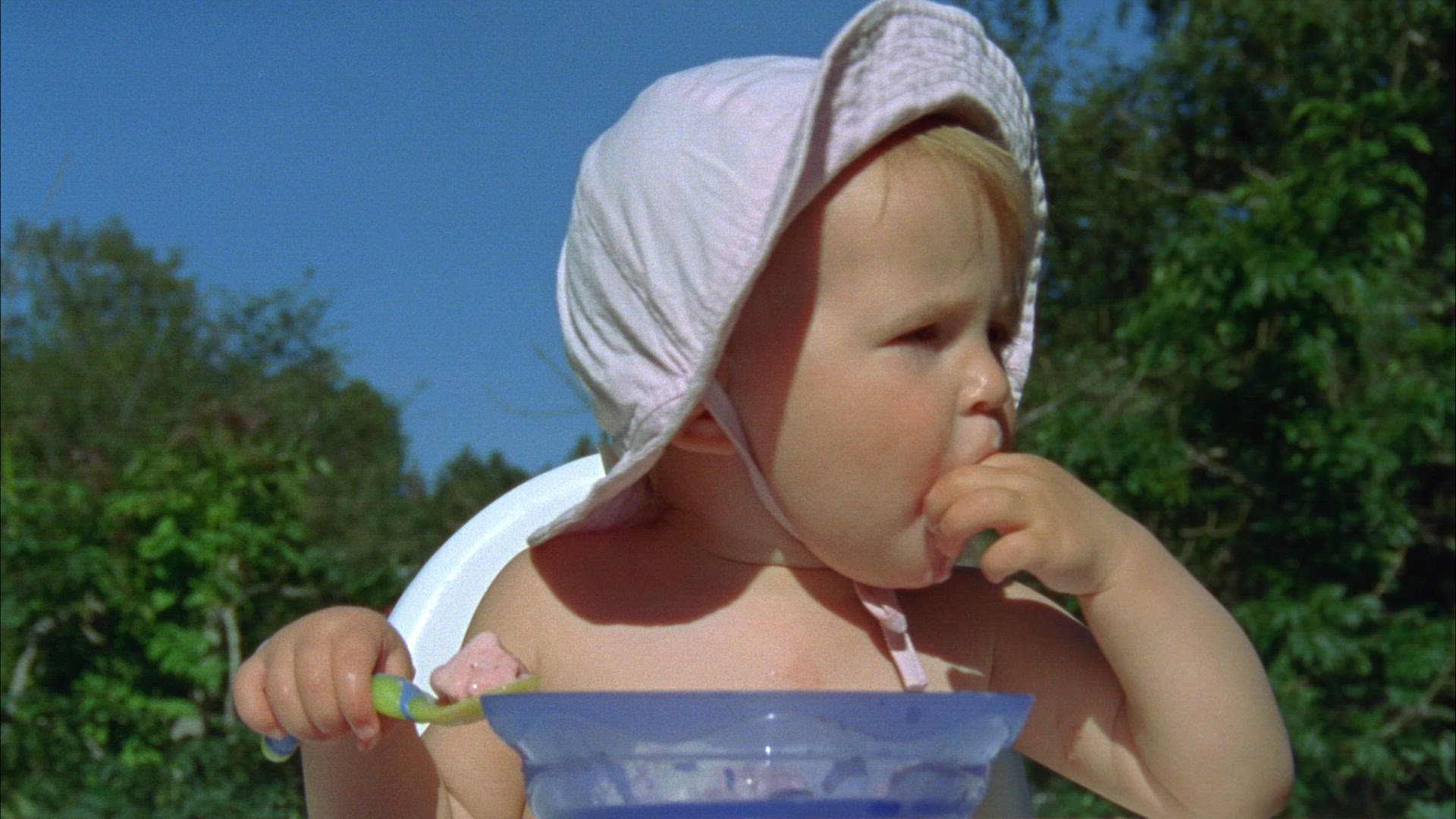 baby girl eating icecream with spoon and with hands - sunbonnet - toddler eating