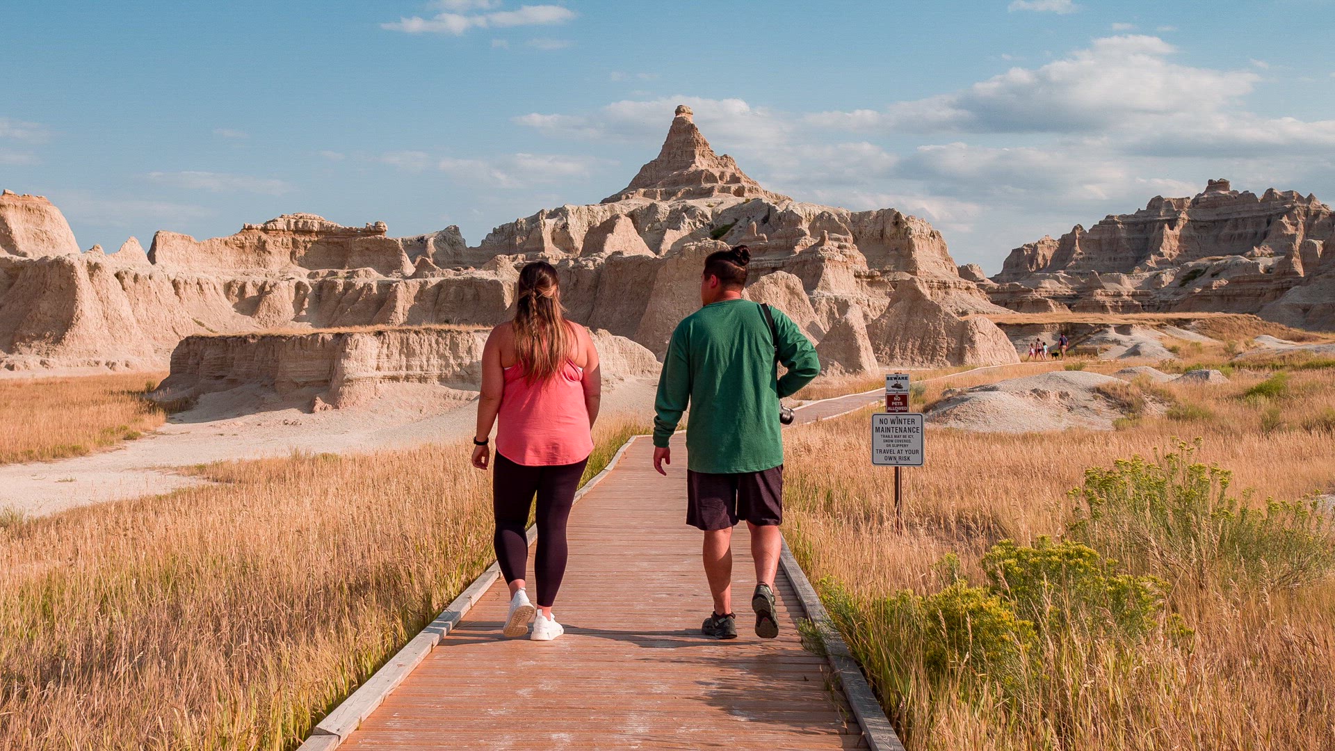 Two people walking trail at badlands National Park