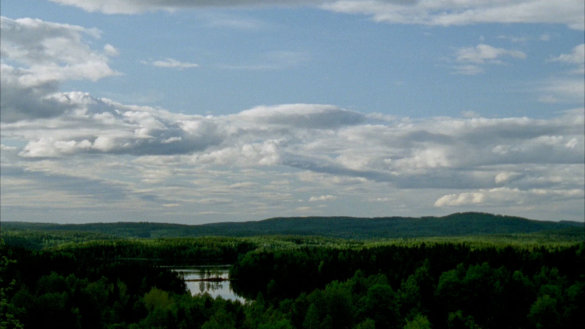 view over forests and lake in Värmland - shot ca 2005 - timelapse shot - clouds moving