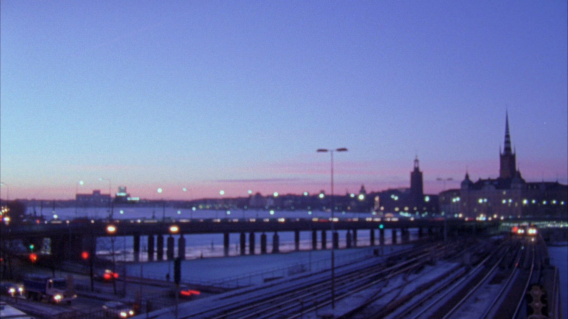 timelapse traffic in central Stockholm - subway trains and cars on bridge - skyline in background