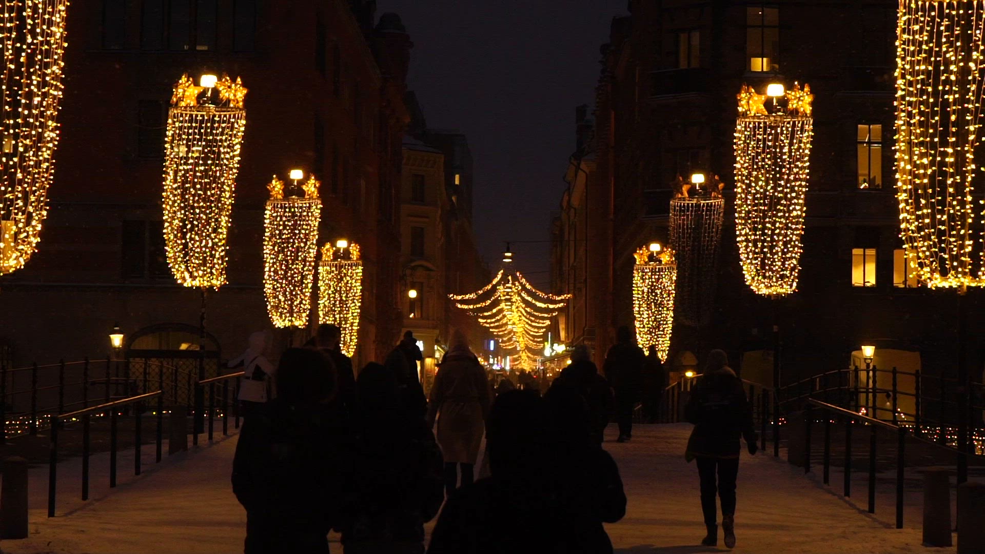 riksbron with christmas decorations - lights - evening shot - slow motion - people walking - dusk