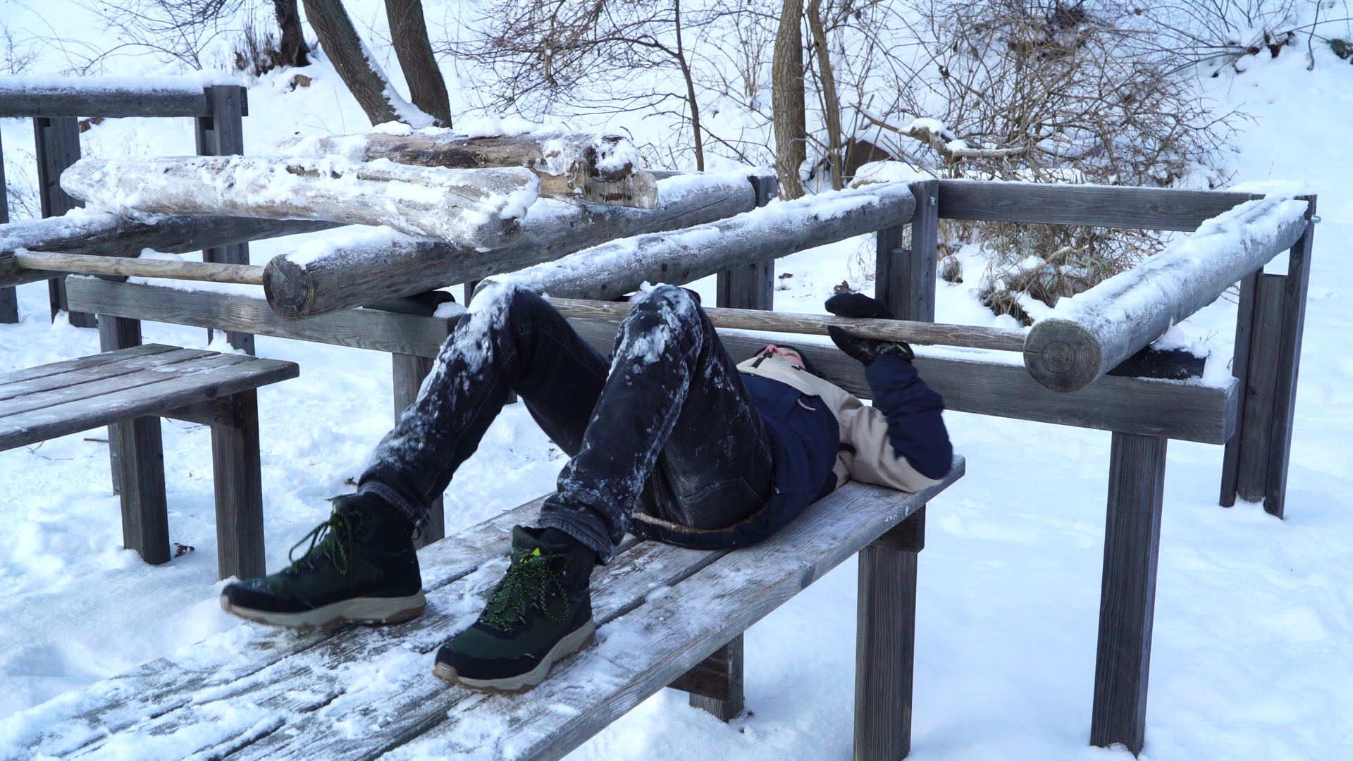 boy lifting weights at snowy outdoor gym in sweden - exercising with heavy weight