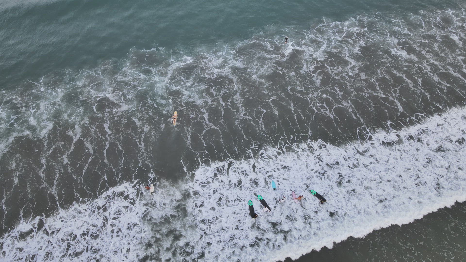 Surfers Catching Waves at Sunrise