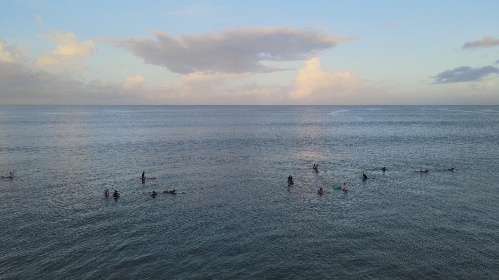 Surfers Catching Waves at Sunrise
