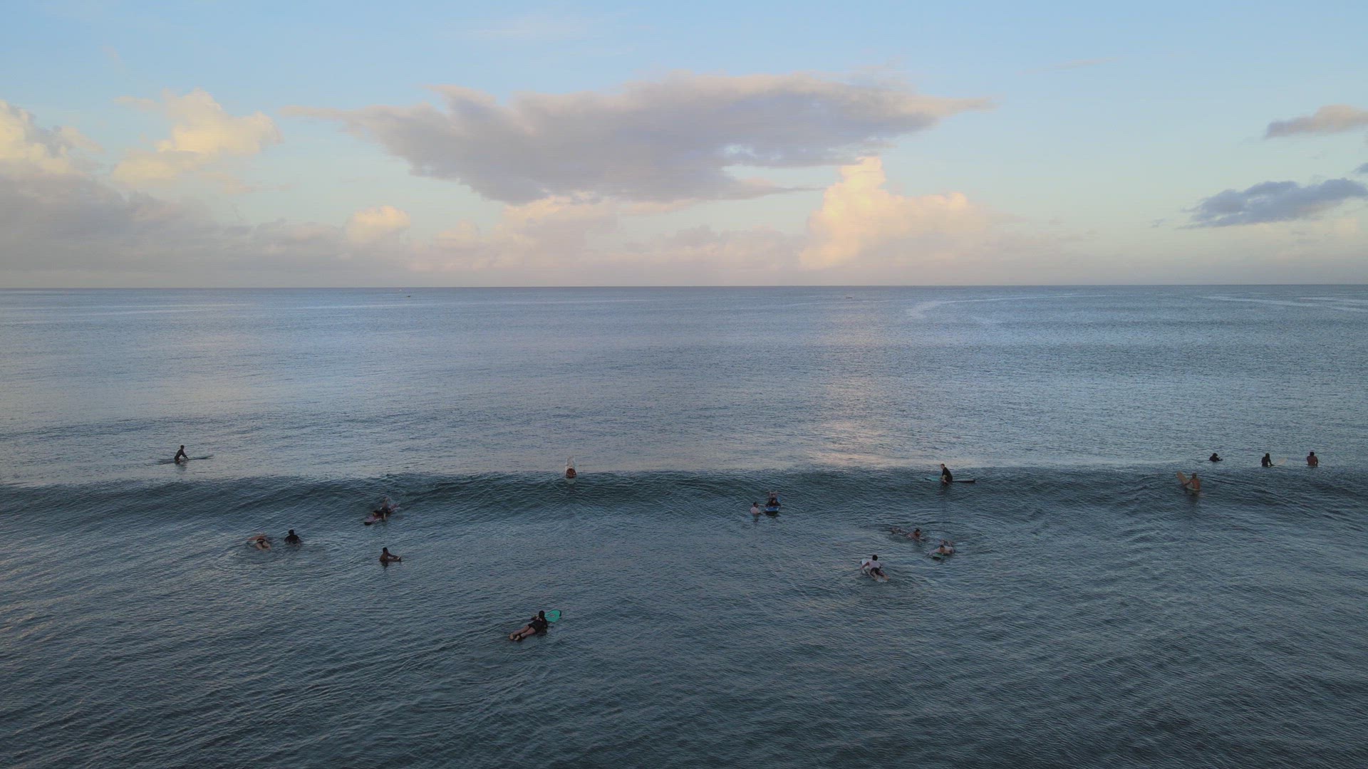 Surfers Catching Waves at Sunrise