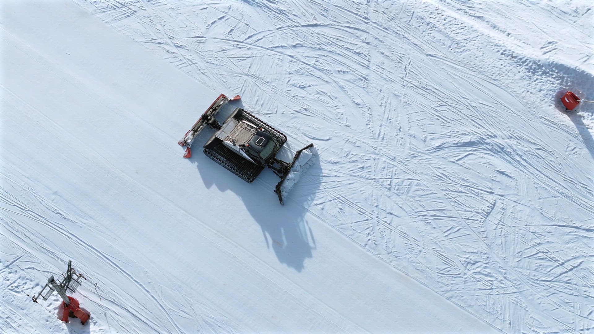 Snow Groomer Working on a Ski Piste Aerial View