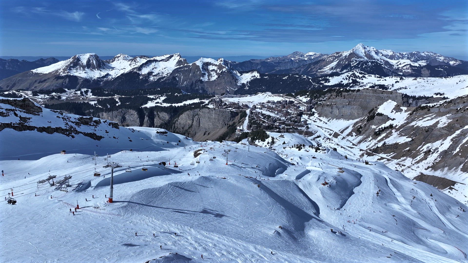 Skiers and Snowboarders on a Slope in a Resort in the French Alps