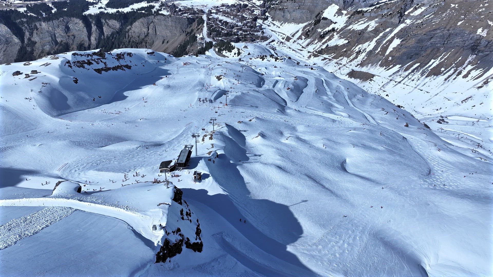 Skiers and Snowboarders on a Slope in a Resort in the French Alps