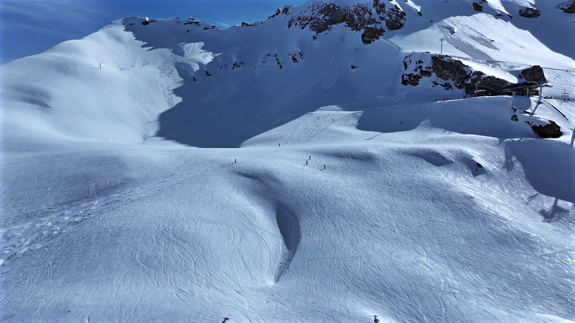 Skiers and Snowboarders on a Slope in a Resort in the French Alps