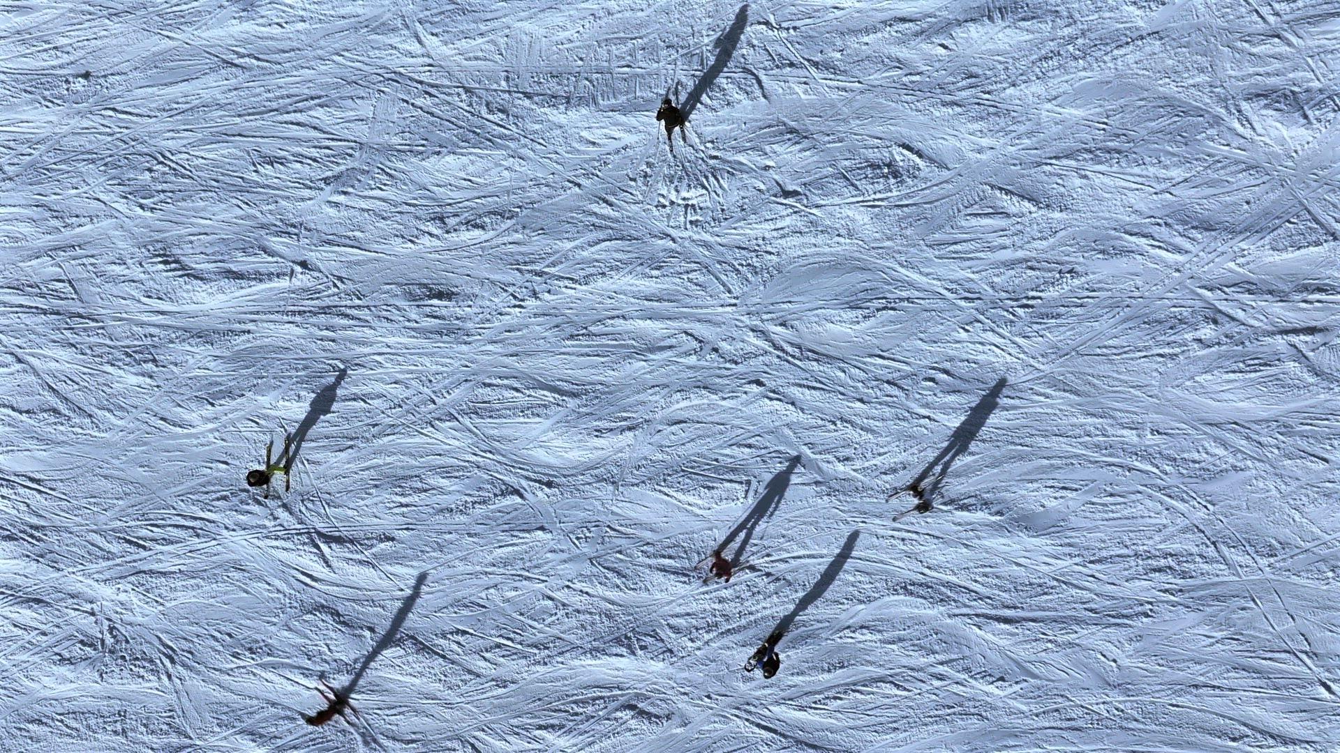 Abstract Aerial View of Skiers on a Slope With Shadows