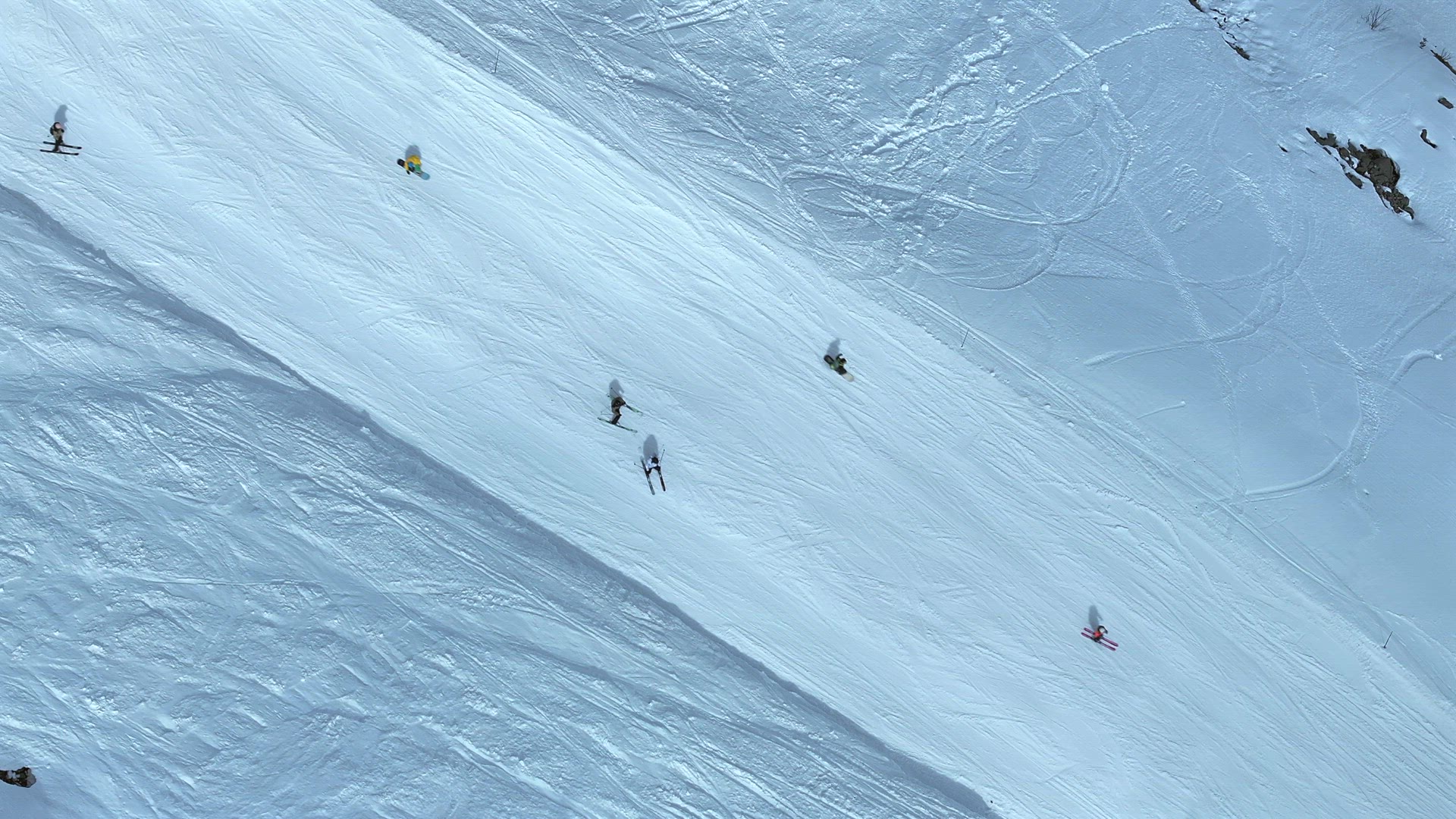 Aerial View of Skiing and Snowboarding Along a Mountainous Run