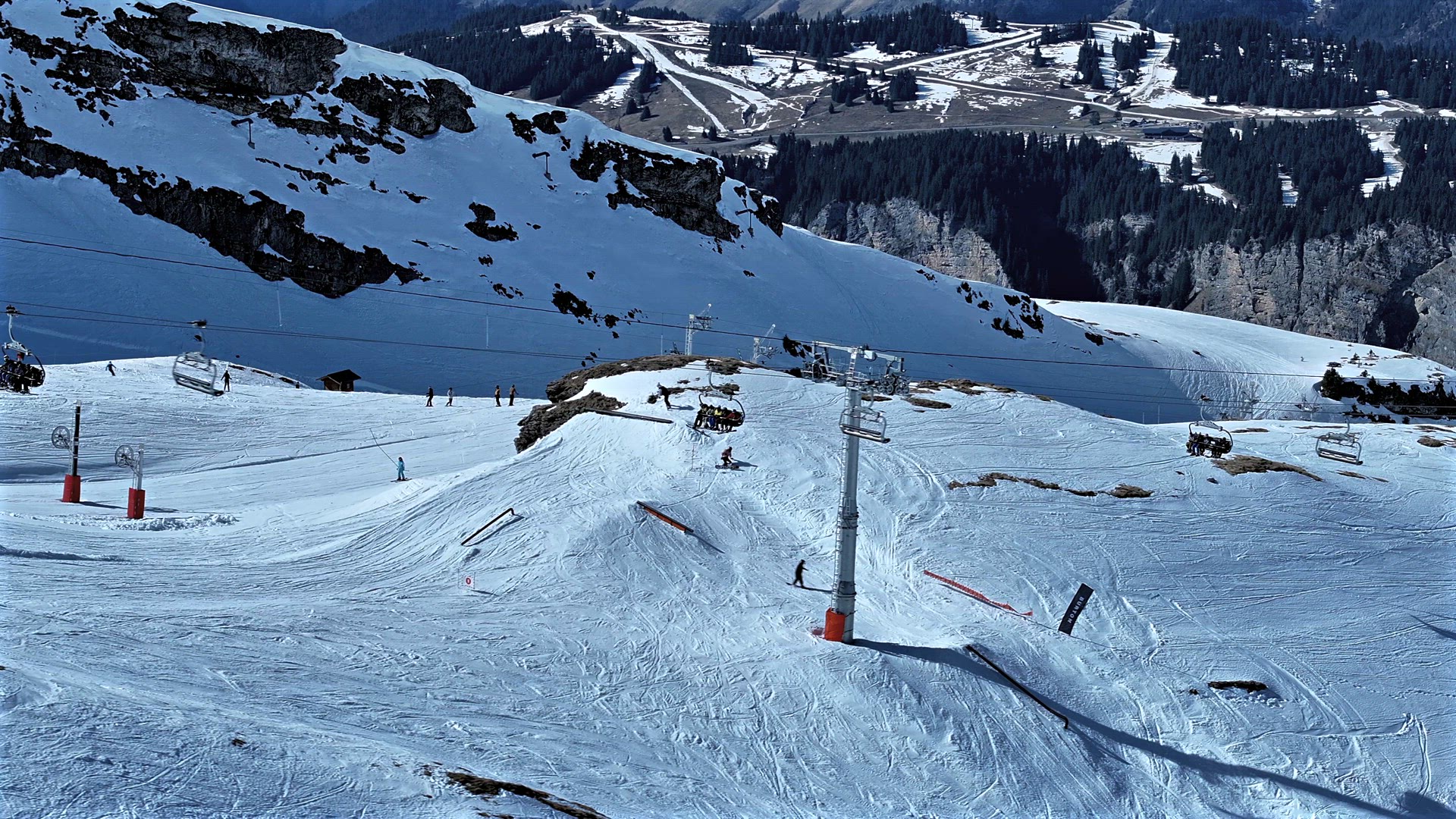 Skiers and Snowboarders Using a Chairlift To Ascend a Mountain