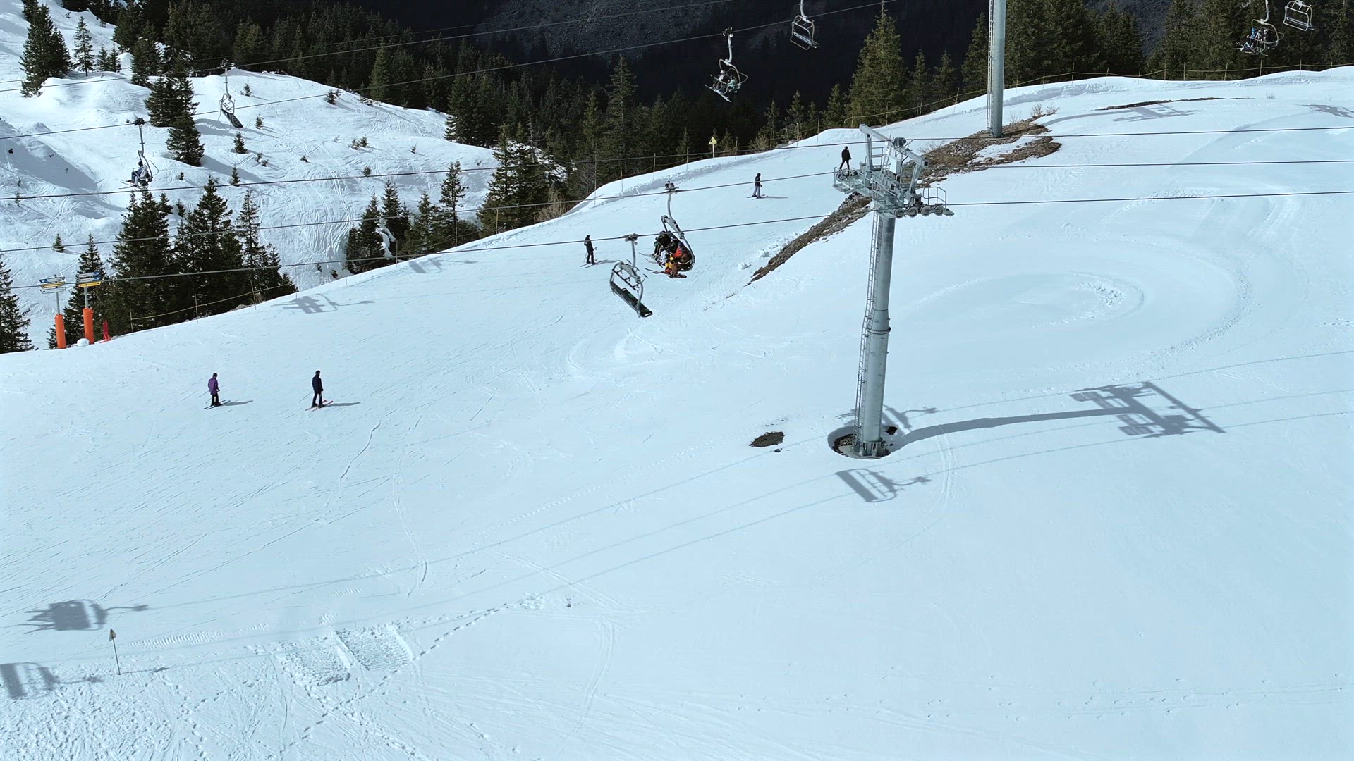 Skiers and Snowboarders Using a Chairlift To Ascend a Mountain