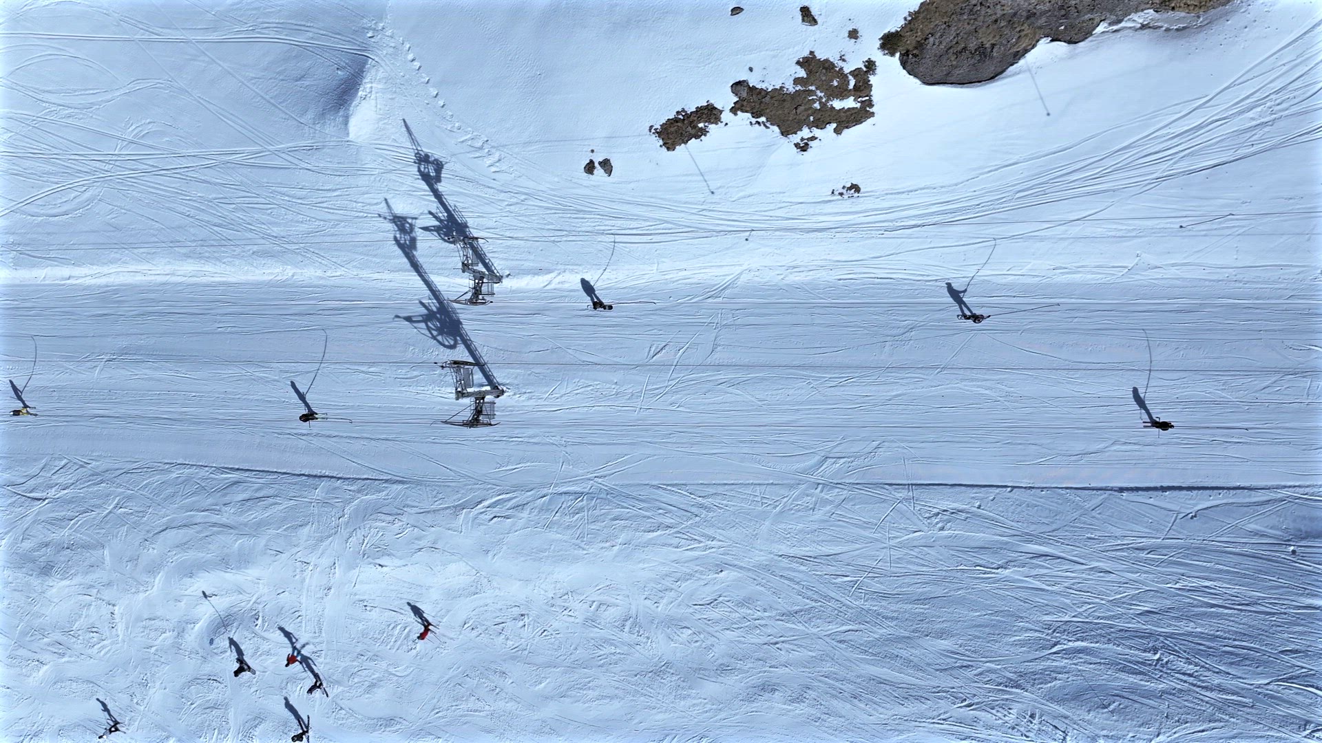 Skiers and Snowboarders Using a Button Lift