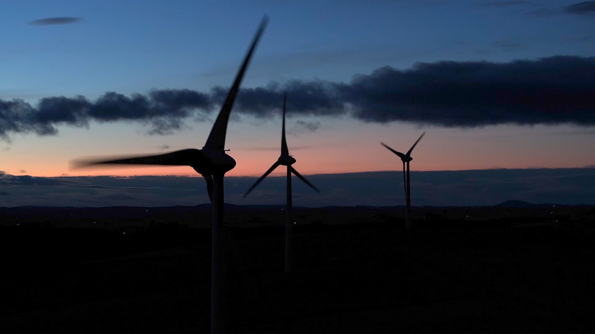 Wind Farm Turbine Operating at Night Generating Renewable Power