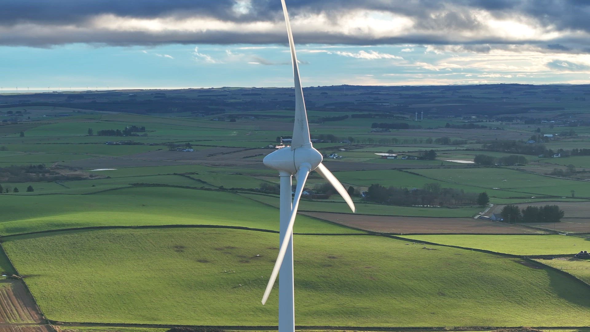 Aerial View of a Large Wind Farm Turbine in the Countryside Generating Power