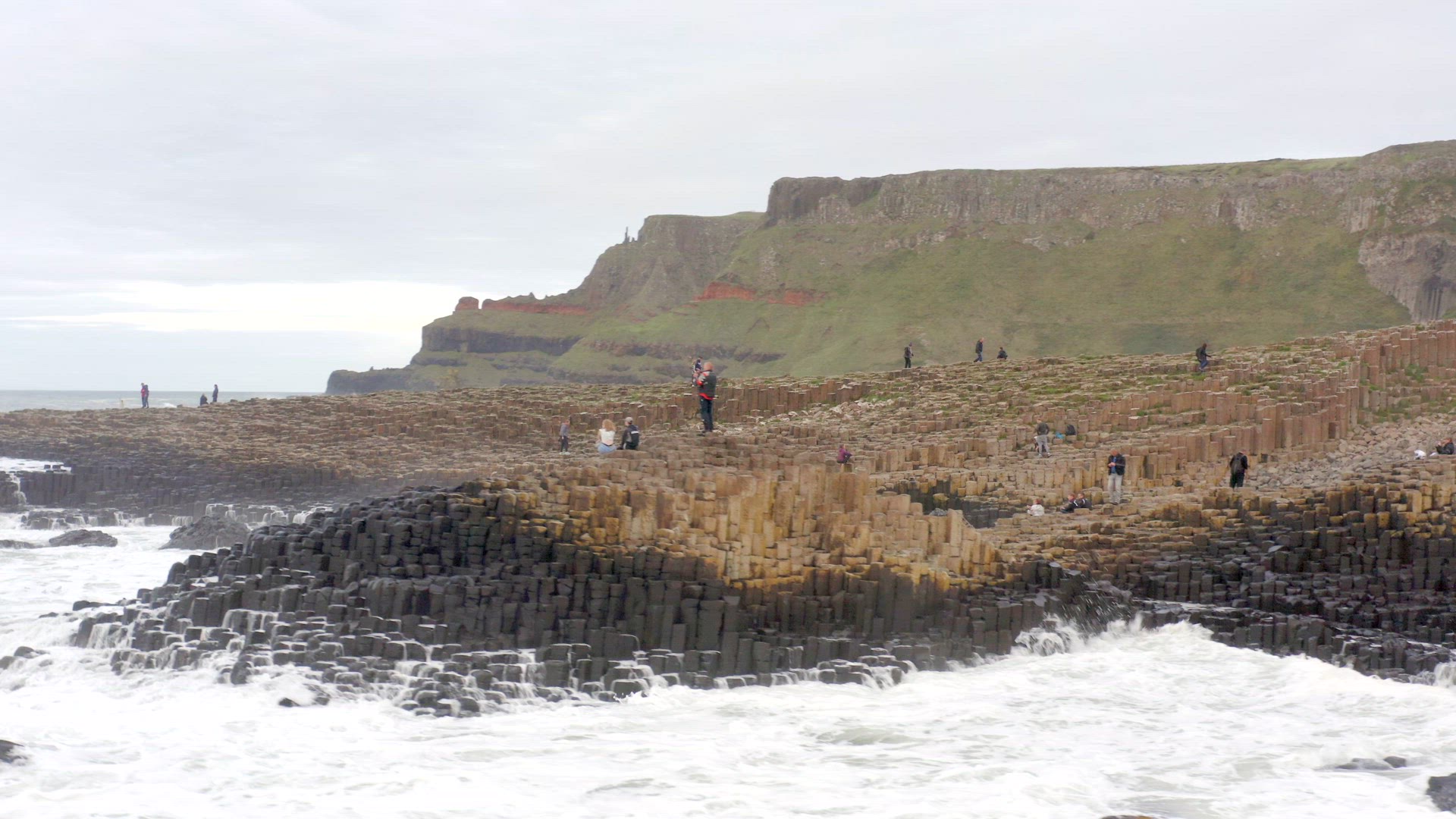 Tourists Exploring Giants Causeway Rock Formation in Northern Ireland